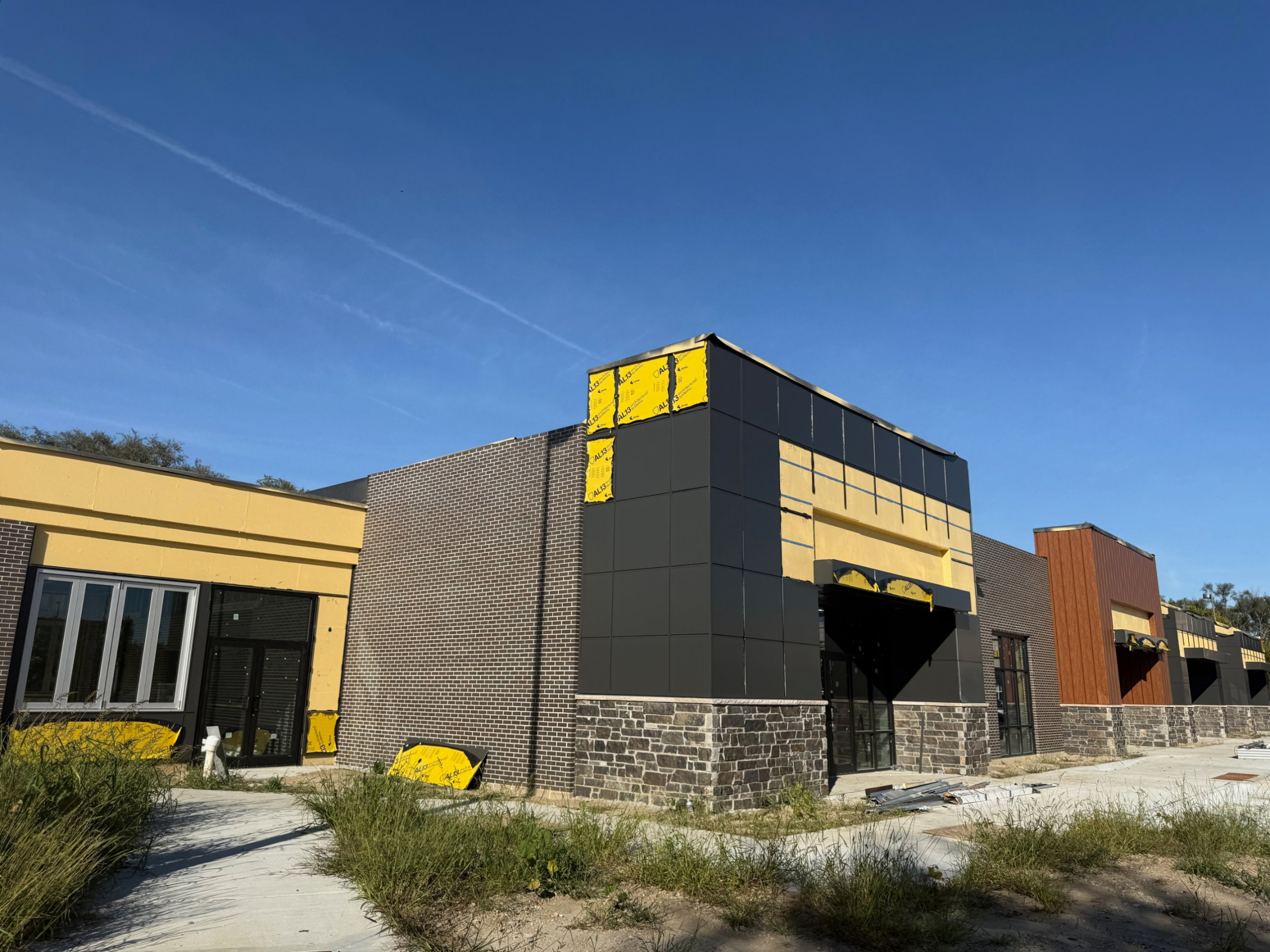 Elk Creek Pines under construction, metal panel and brick storefronts, Omaha NE