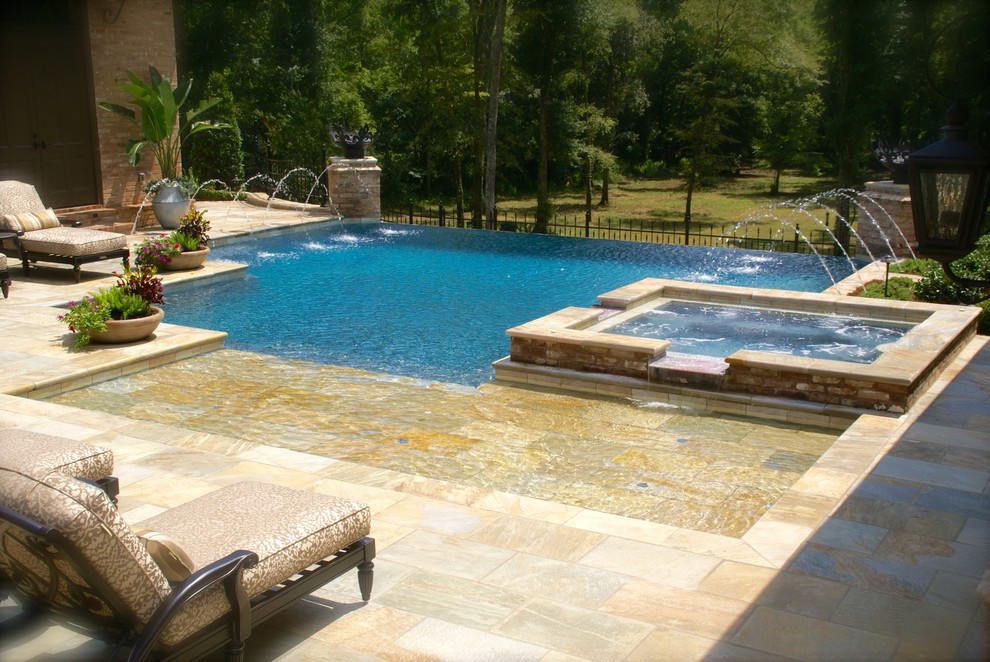 Inspiration for a large transitional backyard concrete paver and custom-shaped infinity pool fountain remodel