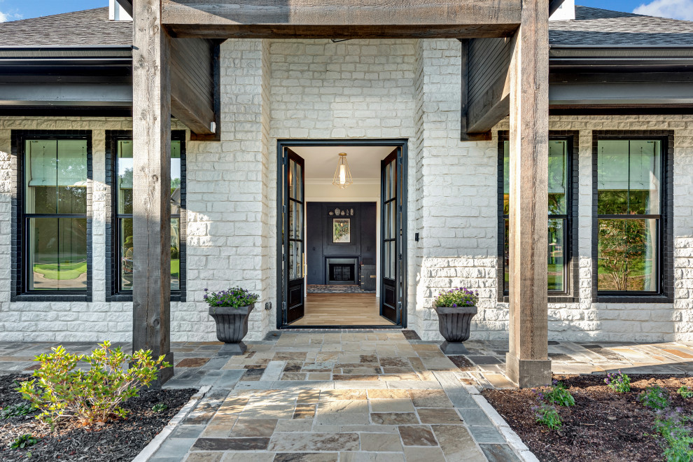 Example of a mid-sized transitional light wood floor front door design in Dallas with a black front door