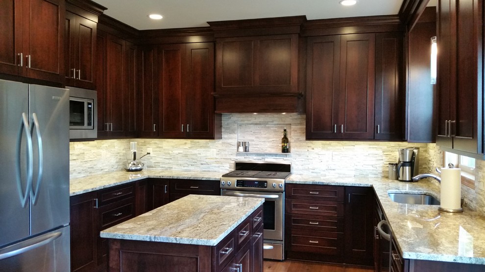 Inspiration for a transitional medium tone wood floor kitchen remodel in Minneapolis with flat-panel cabinets, dark wood cabinets, granite countertops, stone tile backsplash, stainless steel appliances and an island