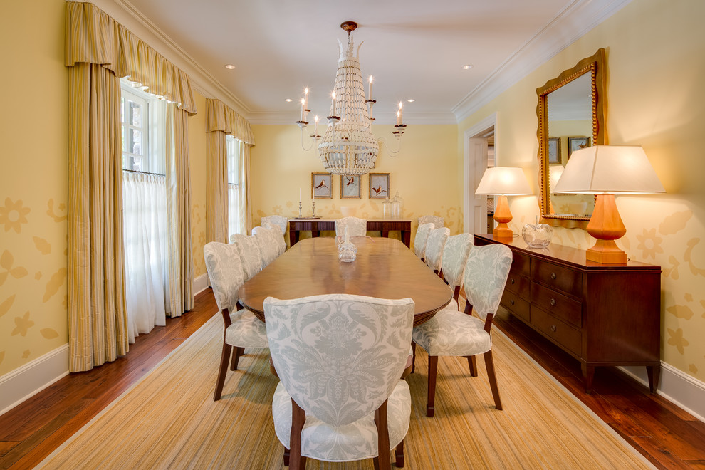 Photo of a large traditional separate dining room in DC Metro with yellow walls and medium hardwood floors.
