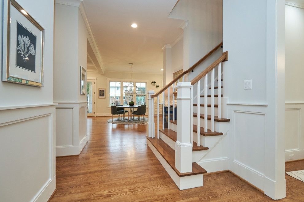 Foyer - mid-sized transitional medium tone wood floor and brown floor foyer idea in DC Metro with white walls