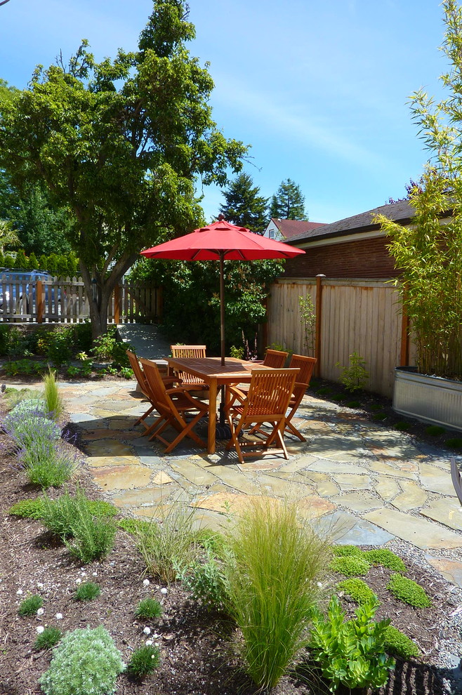 This is an example of a traditional patio in Seattle with natural stone pavers.