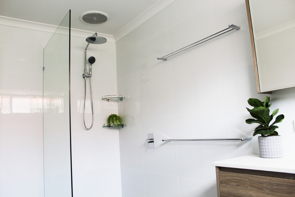 This is an example of a large modern kids bathroom in Perth with flat-panel cabinets, brown cabinets, a drop-in tub, an open shower, white tile, ceramic tile, white walls, porcelain floors, a vessel sink, engineered quartz benchtops, grey floor, an open shower and white benchtops.