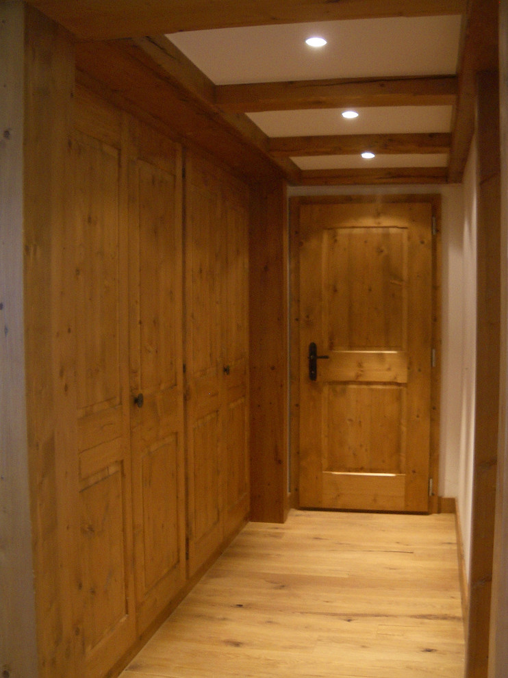 This is an example of a mid-sized transitional hallway in Other with white walls, light hardwood floors and beige floor.