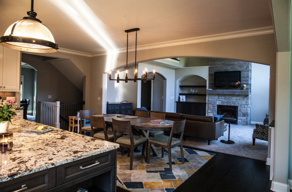 Open concept kitchen - transitional dark wood floor and brown floor open concept kitchen idea with an undermount sink, shaker cabinets, white cabinets, granite countertops, beige backsplash, subway tile backsplash, stainless steel appliances and an island