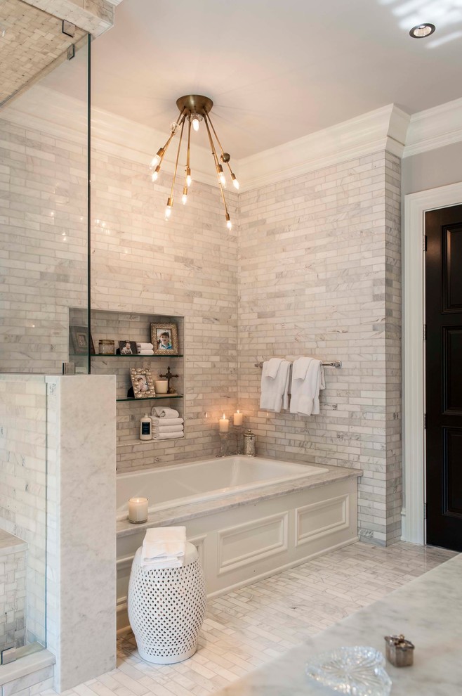 Photo of a transitional master bathroom in Indianapolis with grey walls, marble benchtops, a drop-in tub and gray tile.