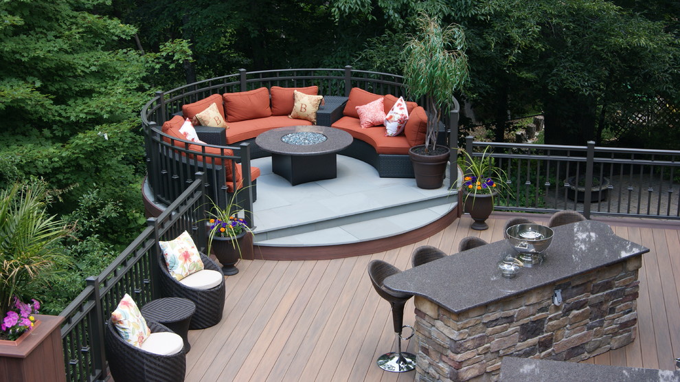 This is an example of a mid-sized contemporary backyard deck in New York with a fire feature and no cover.