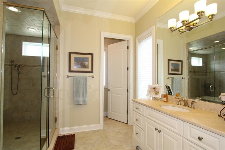 Photo of a mid-sized transitional master bathroom in Cincinnati with an undermount sink, white cabinets, granite benchtops, a japanese tub, a shower/bathtub combo, a one-piece toilet, beige tile, ceramic tile, yellow walls and ceramic floors.