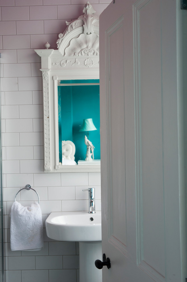 Inspiration for an eclectic master bathroom in Gloucestershire with a pedestal sink, light wood cabinets, a freestanding tub, a corner shower, a one-piece toilet, white tile, ceramic tile, white walls and ceramic floors.