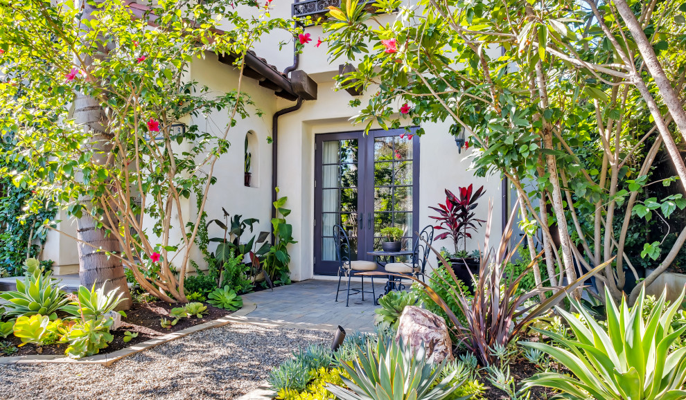 Inspiration for a mid-sized mediterranean front yard full sun xeriscape in Los Angeles with concrete pavers.