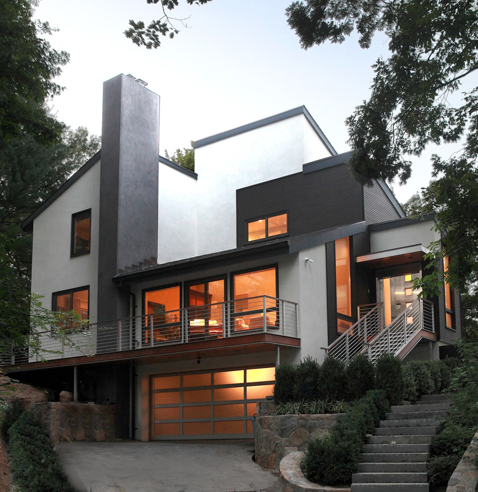 Mid-sized modern two-storey concrete white house exterior in New York with a shed roof.