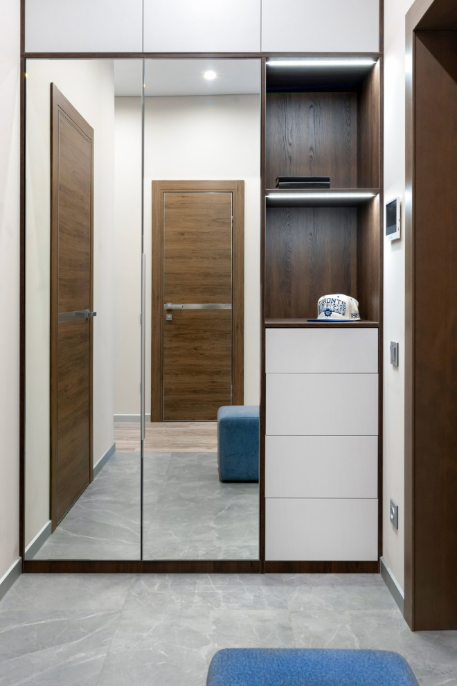 Mid-sized contemporary front door in Other with grey walls, porcelain floors, a single front door, a medium wood front door, grey floor and decorative wall panelling.