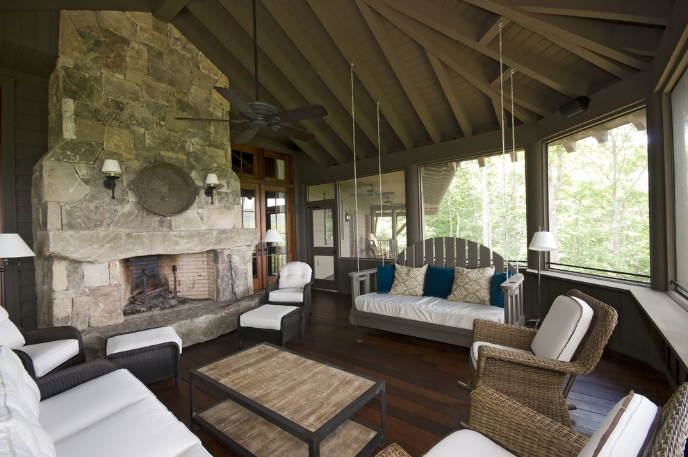 Photo of a traditional sunroom in Atlanta with dark hardwood floors, a standard ceiling and brown floor.
