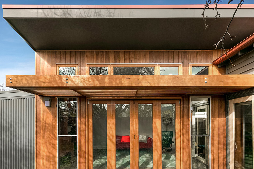 Mid-sized modern backyard verandah in Melbourne with a pergola.