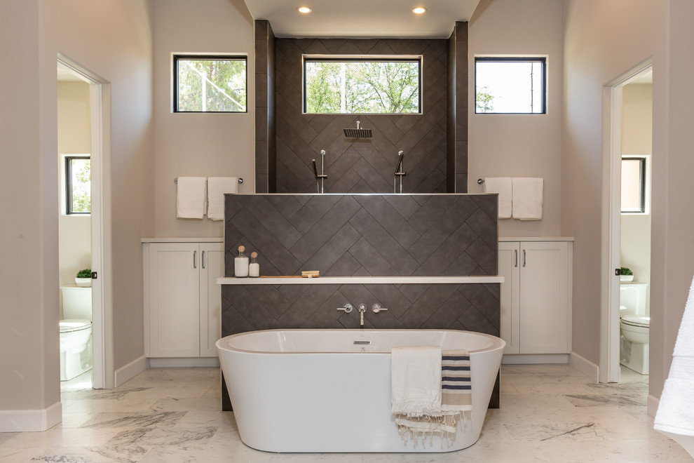 Inspiration for a transitional medium tone wood floor and brown floor bathroom remodel in Phoenix with furniture-like cabinets, gray cabinets, gray walls, an undermount sink and white countertops