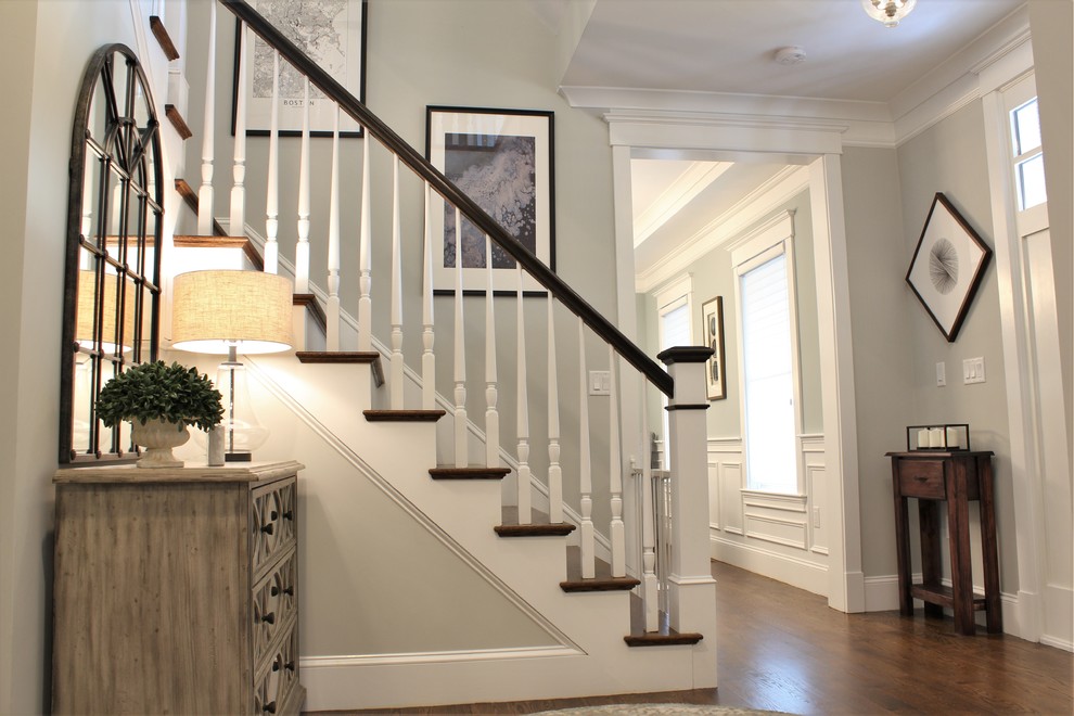 Inspiration for a mid-sized transitional dark wood floor and brown floor foyer remodel in Boston with gray walls and a white front door