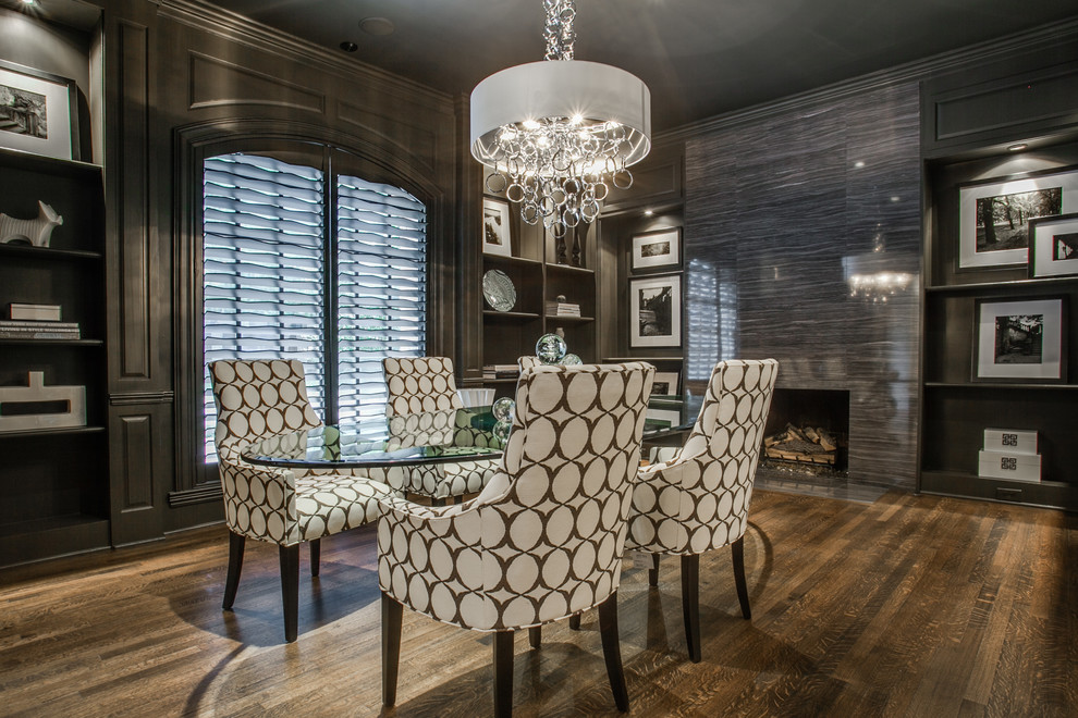 This is an example of a mid-sized modern separate dining room in Dallas with dark hardwood floors, a standard fireplace, a tile fireplace surround and grey walls.