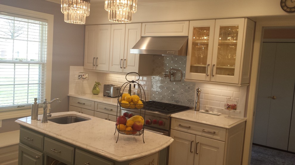 Inspiration for a small transitional u-shaped ceramic tile eat-in kitchen remodel with an undermount sink, raised-panel cabinets, white cabinets, marble countertops, white backsplash, subway tile backsplash, stainless steel appliances and an island