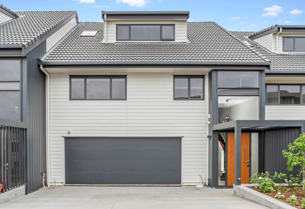Design ideas for an expansive modern attached two-car garage in Auckland.