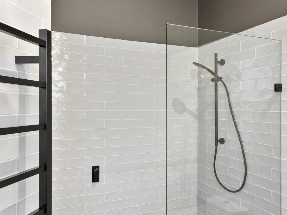 Design ideas for a mid-sized contemporary master bathroom in Perth with an open shower, a one-piece toilet, black and white tile, subway tile, white walls, ceramic floors, a vessel sink, wood benchtops and black floor.