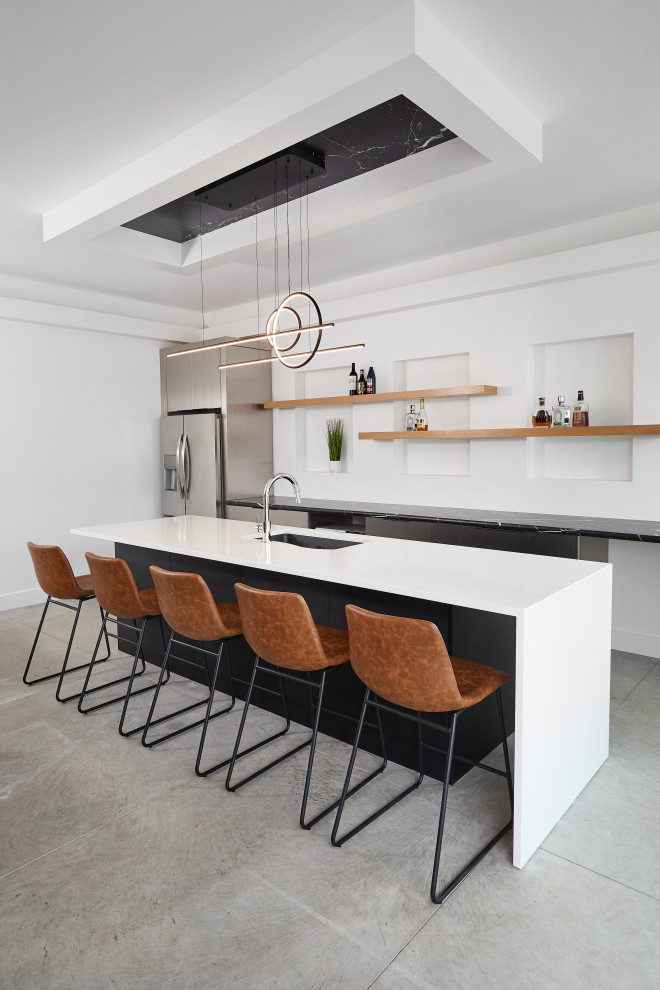 Large contemporary single-wall wet bar in Grand Rapids with an undermount sink, flat-panel cabinets, black cabinets, quartz benchtops, concrete floors, grey floor and black benchtop.