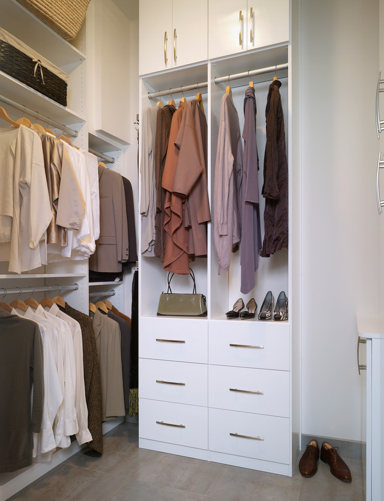 Photo of a small contemporary gender-neutral walk-in wardrobe in Atlanta with flat-panel cabinets, white cabinets and porcelain floors.