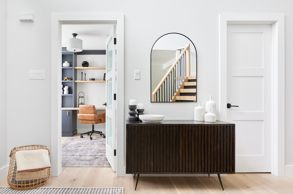 Inspiration for a mid-sized transitional light wood floor and brown floor foyer remodel