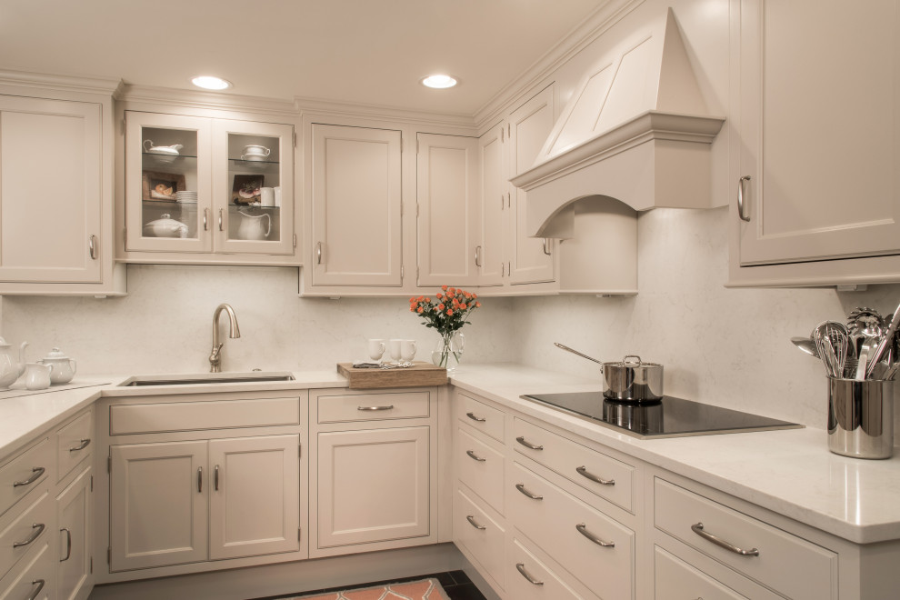 Eat-in kitchen - small transitional ceramic tile and black floor eat-in kitchen idea with an undermount sink, beaded inset cabinets, gray cabinets, white backsplash, stainless steel appliances and white countertops