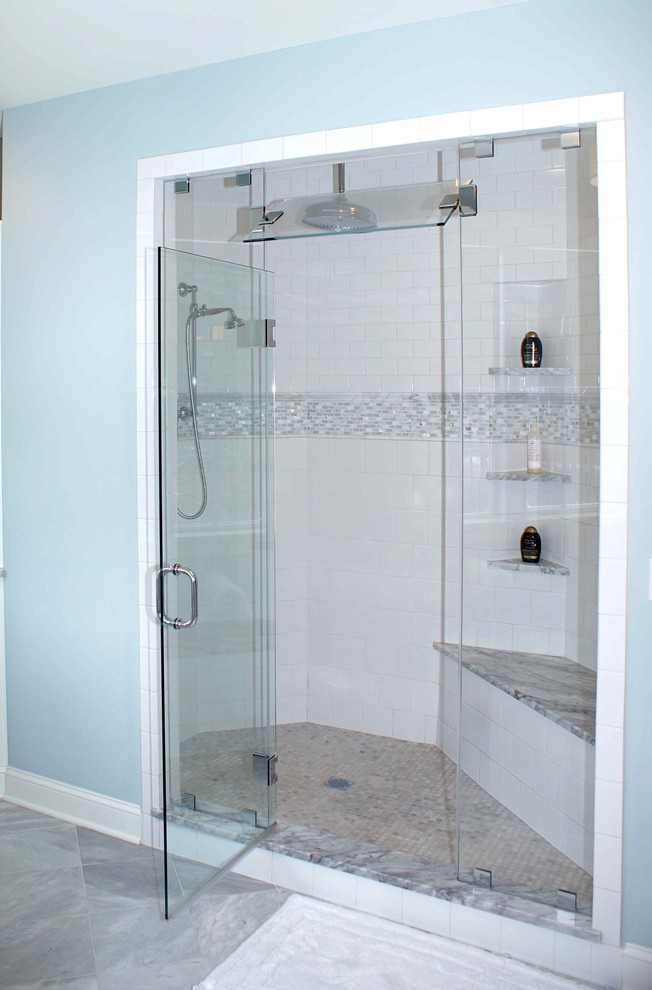 Mid-sized transitional master white tile and ceramic tile marble floor bathroom photo with an undermount sink, recessed-panel cabinets, white cabinets, marble countertops and blue walls