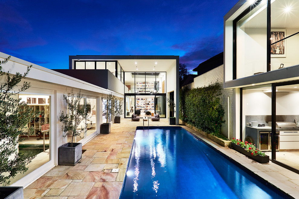 Design ideas for a mid-sized contemporary rectangular pool in Melbourne with a pool house.