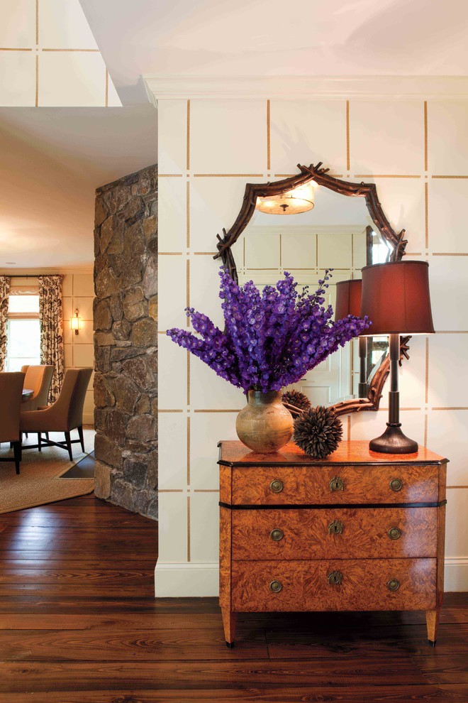 Inspiration for a traditional entryway in New York with beige walls and dark hardwood floors.