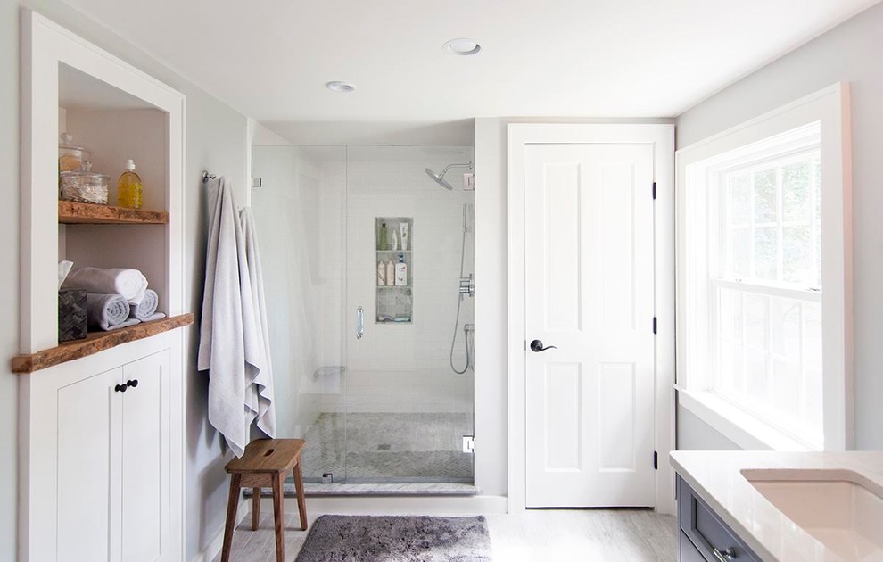 Example of a large transitional master white tile and subway tile ceramic tile and gray floor alcove shower design in Boston with recessed-panel cabinets, white cabinets, gray walls, an undermount sink, laminate countertops and a hinged shower door