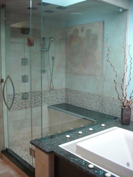 Design ideas for a large transitional bathroom in Cleveland with flat-panel cabinets, dark wood cabinets, a hot tub, a two-piece toilet, blue tile, mosaic tile, blue walls, porcelain floors, a vessel sink, granite benchtops, with a sauna and a corner shower.