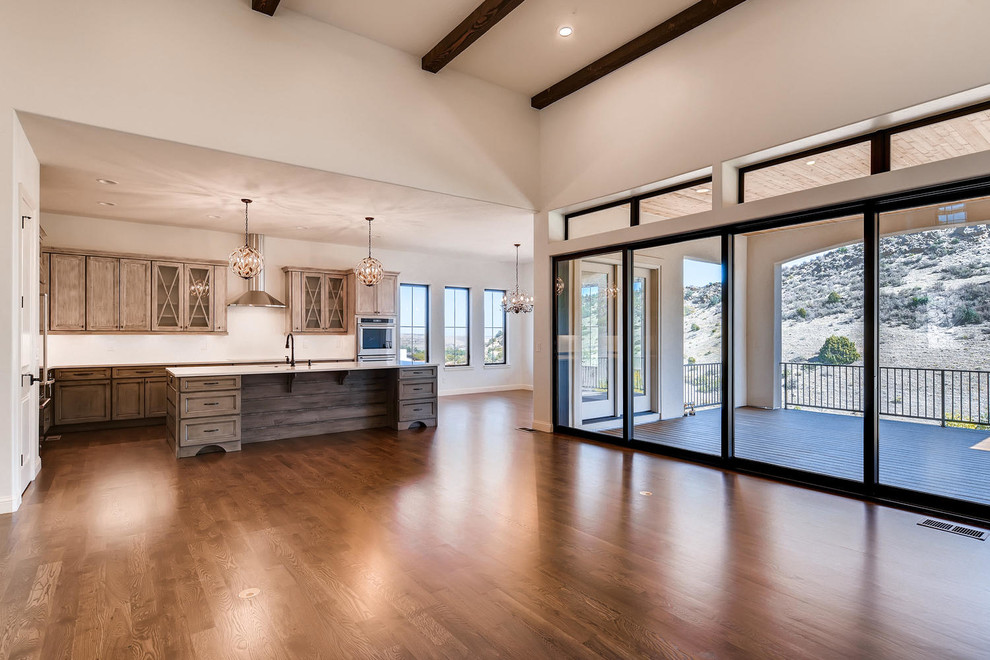 Open concept kitchen - large transitional l-shaped medium tone wood floor and brown floor open concept kitchen idea in Denver with flat-panel cabinets, medium tone wood cabinets, granite countertops, stainless steel appliances and an island