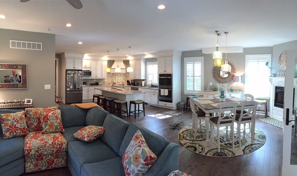 Mid-sized transitional l-shaped medium tone wood floor open concept kitchen photo in Baltimore with white cabinets, granite countertops, multicolored backsplash, matchstick tile backsplash, stainless steel appliances and an island