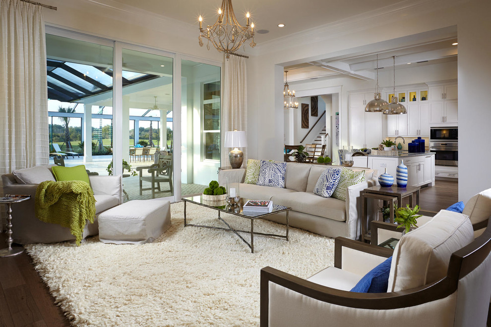 Photo of a transitional open concept living room in Tampa with beige walls and dark hardwood floors.