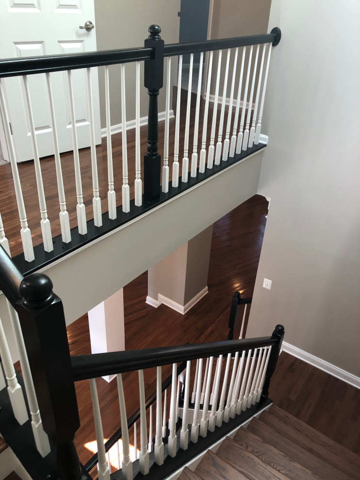 Design ideas for a mid-sized transitional wood u-shaped staircase in DC Metro with painted wood risers and wood railing.