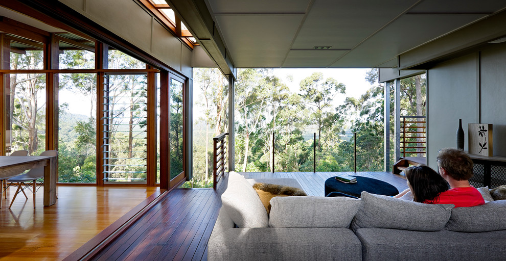 Photo of a mid-sized contemporary deck in Brisbane with a roof extension.