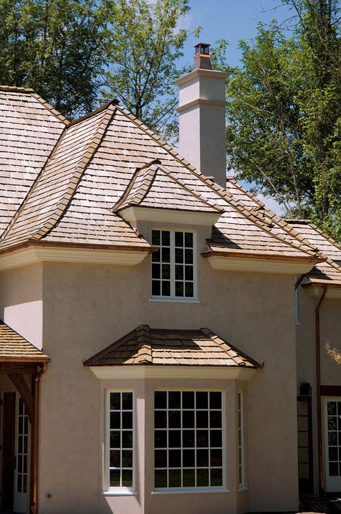 This is an example of a large traditional two-storey stucco white exterior in Portland.