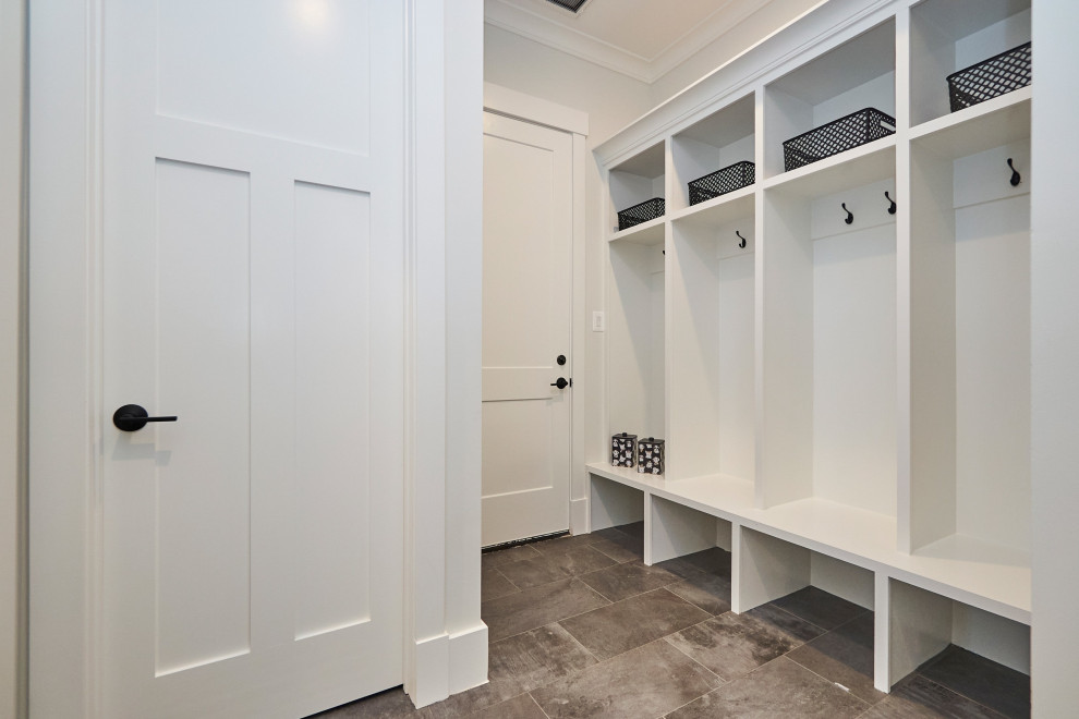 Inspiration for a mid-sized transitional porcelain tile and gray floor mudroom remodel in DC Metro with white walls