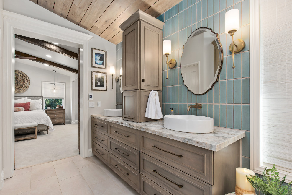 This is an example of a transitional master bathroom in Los Angeles with recessed-panel cabinets, brown cabinets, blue tile, subway tile, white walls, a vessel sink, beige floor, multi-coloured benchtops, a double vanity, a built-in vanity, vaulted and wood.