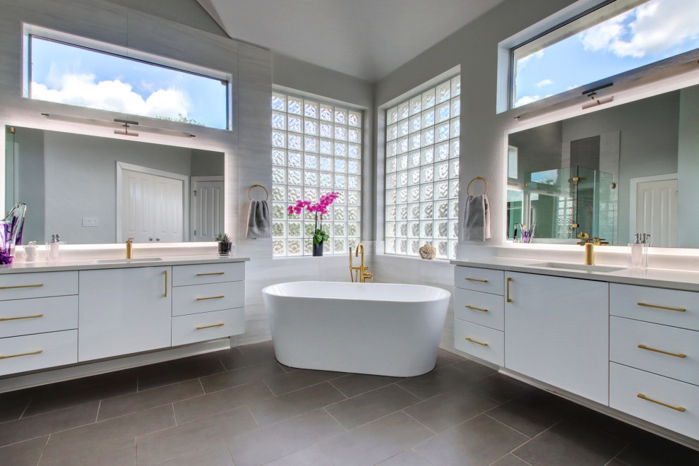 Inspiration for a large modern gray tile and glass tile gray floor and double-sink bathroom remodel in Austin with flat-panel cabinets, gray cabinets, gray walls, an undermount sink, quartz countertops, a hinged shower door, white countertops and a floating vanity