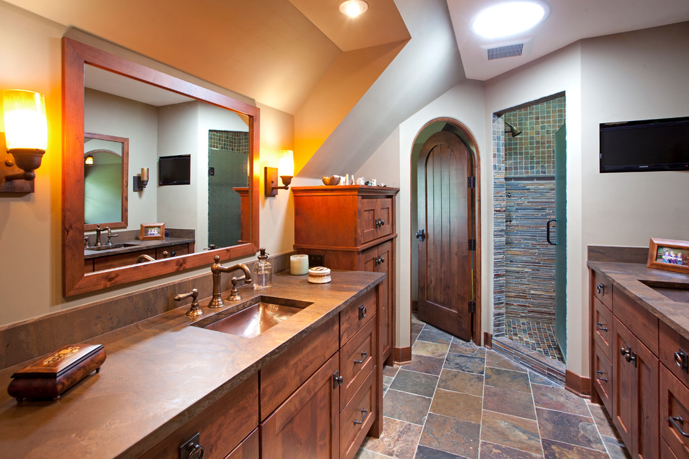 Photo of a large country master bathroom in Minneapolis with an undermount sink, medium wood cabinets, recessed-panel cabinets, slate and brown benchtops.