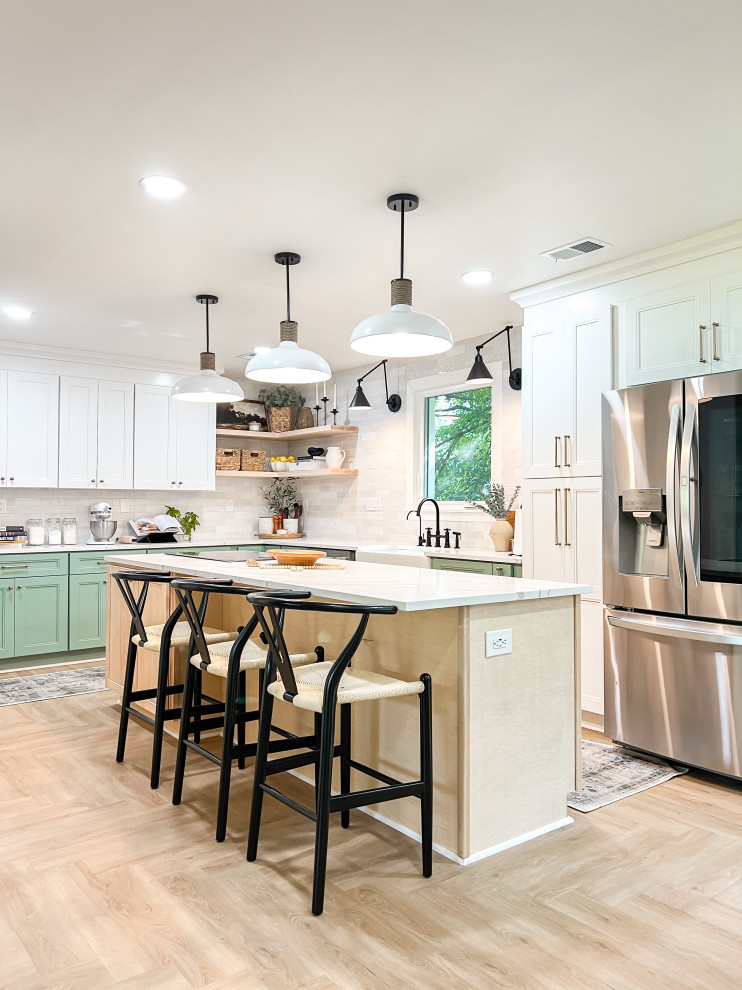 Design ideas for a large transitional u-shaped eat-in kitchen in DC Metro with a farmhouse sink, shaker cabinets, green cabinets, quartzite benchtops, white splashback, porcelain splashback, stainless steel appliances, vinyl floors, with island, beige floor, white benchtop and coffered.