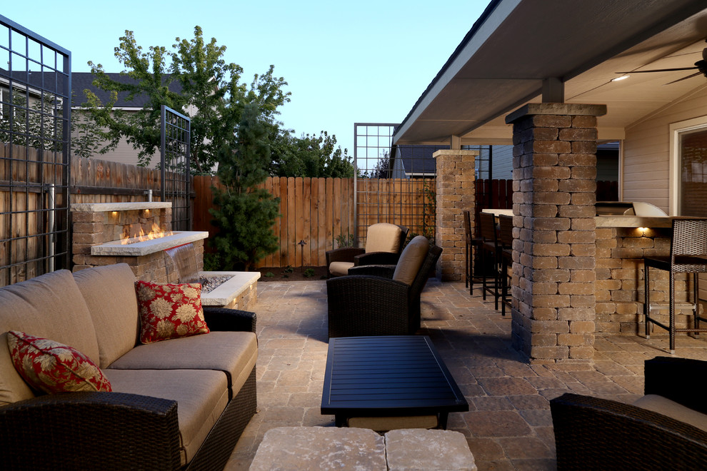 This is an example of a mid-sized midcentury backyard patio in Other with a fire feature and brick pavers.