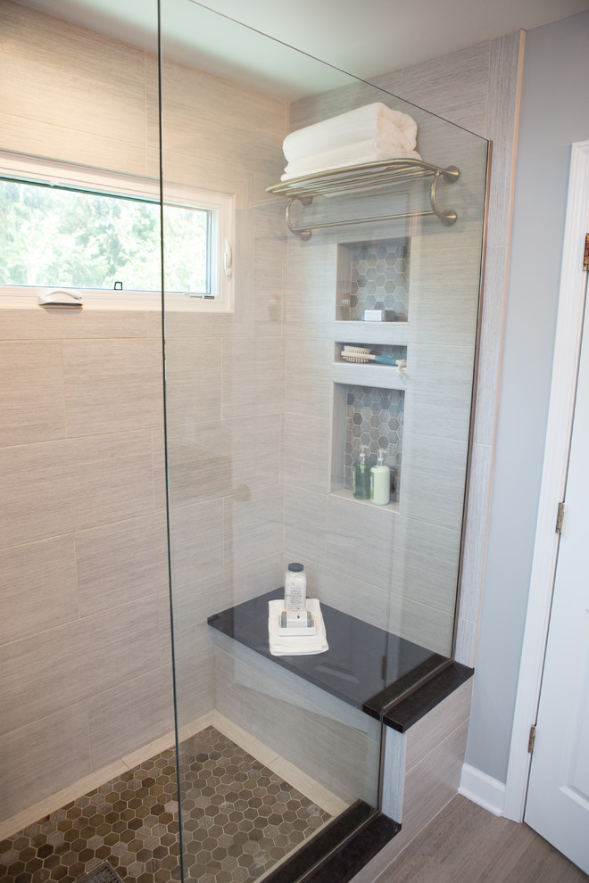 Inspiration for a mid-sized transitional master bathroom in Chicago with recessed-panel cabinets, an alcove shower, a two-piece toilet, gray tile, porcelain tile, grey walls, porcelain floors, an undermount sink, granite benchtops, grey floor and a hinged shower door.