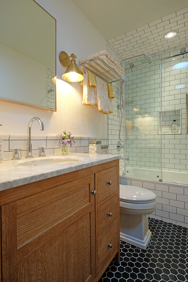 Small transitional white tile and subway tile ceramic tile alcove bathtub photo in Chicago with medium tone wood cabinets, white walls, an undermount sink, shaker cabinets, marble countertops and a one-piece toilet