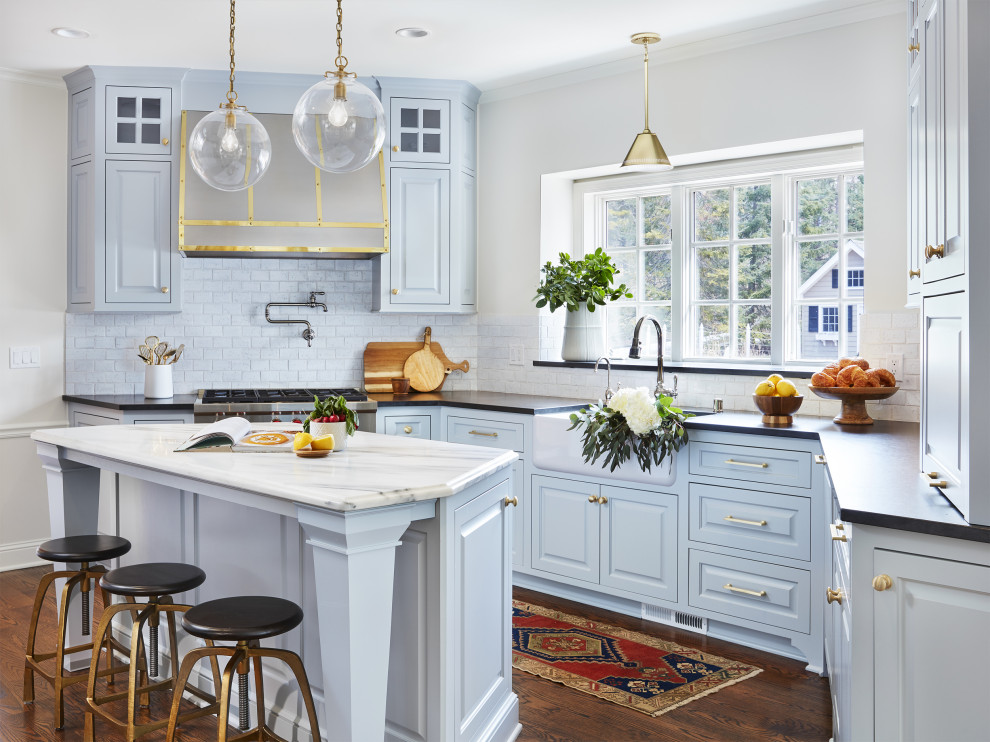 Inspiration for a small traditional u-shaped separate kitchen in Minneapolis with a farmhouse sink, blue cabinets, white splashback, ceramic splashback, panelled appliances, dark hardwood floors and with island.