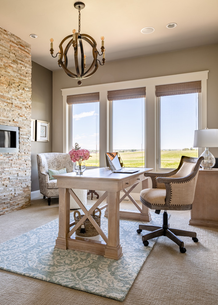 Small country home office in Denver with grey walls, carpet, a standard fireplace, a stone fireplace surround, a freestanding desk and grey floor.